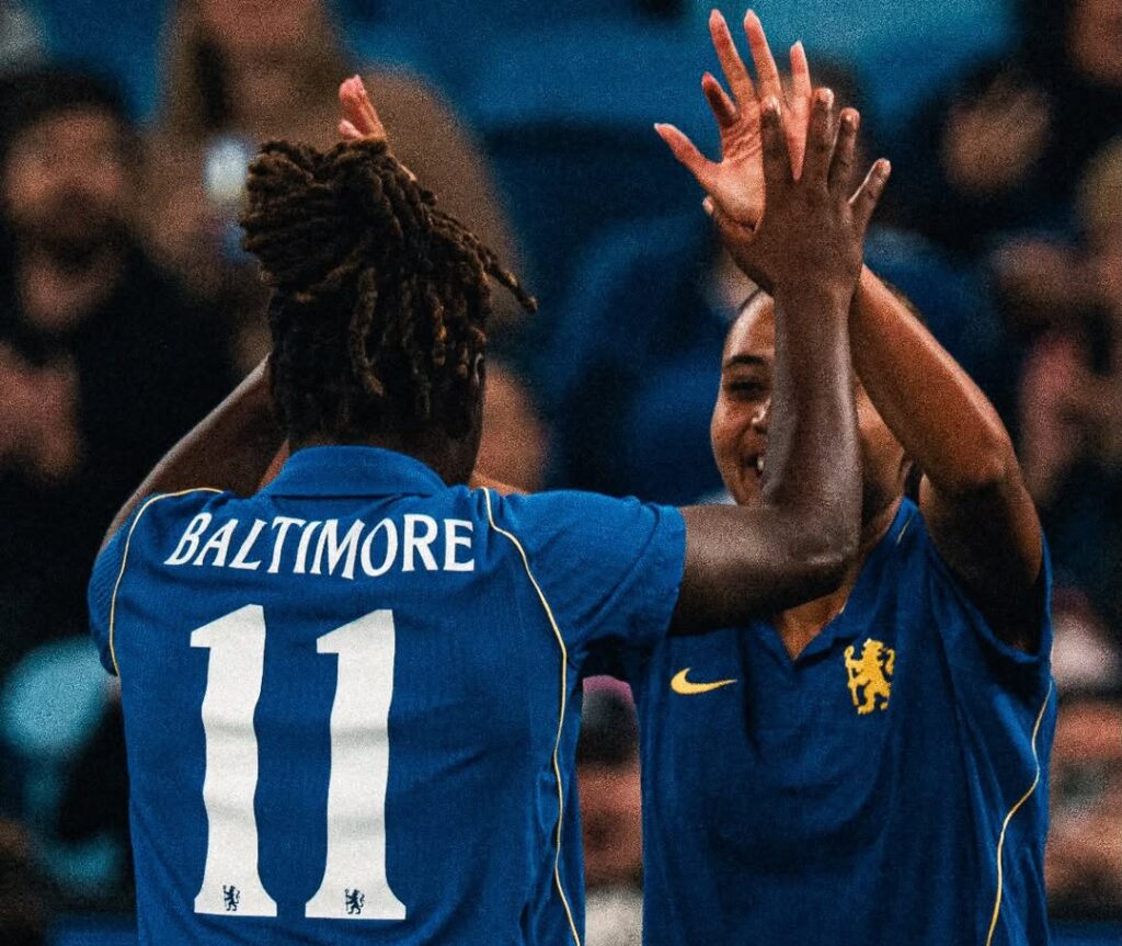 Alyssa Thompson and Sandy Baltimore celebrate a goal.
