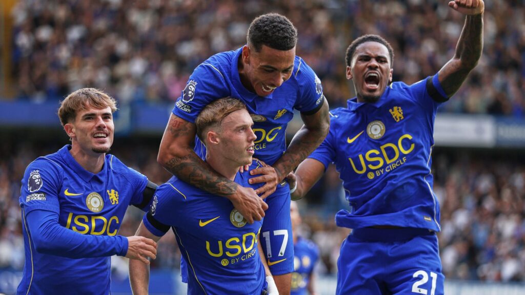 Cole Palmer celebrating with Chelsea teammates during a football match.