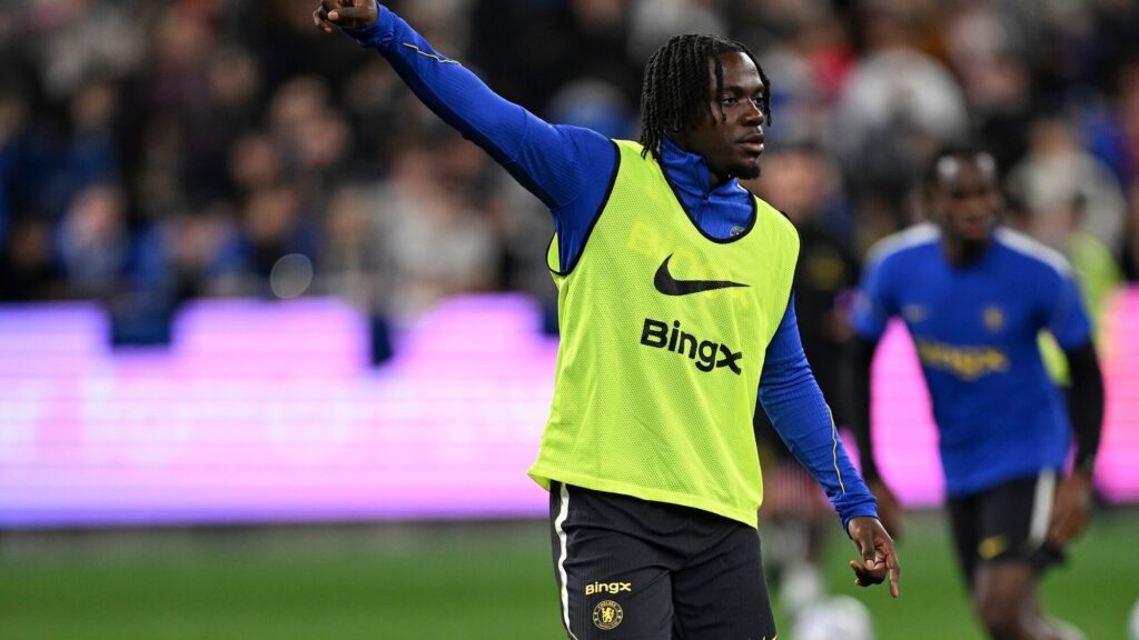 Romeo Lavia Chelsea injury: Romeo Lavia in Chelsea training kit pointing during a warm-up session.